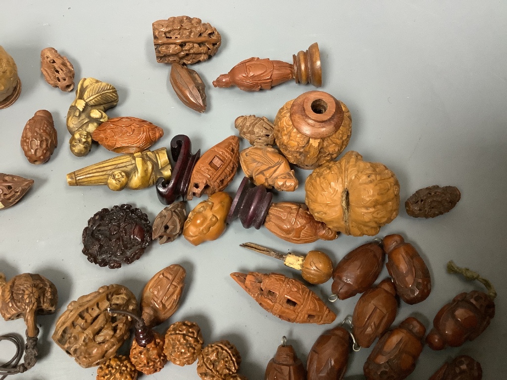 An assortment of Chinese peach stone and a nut carvings